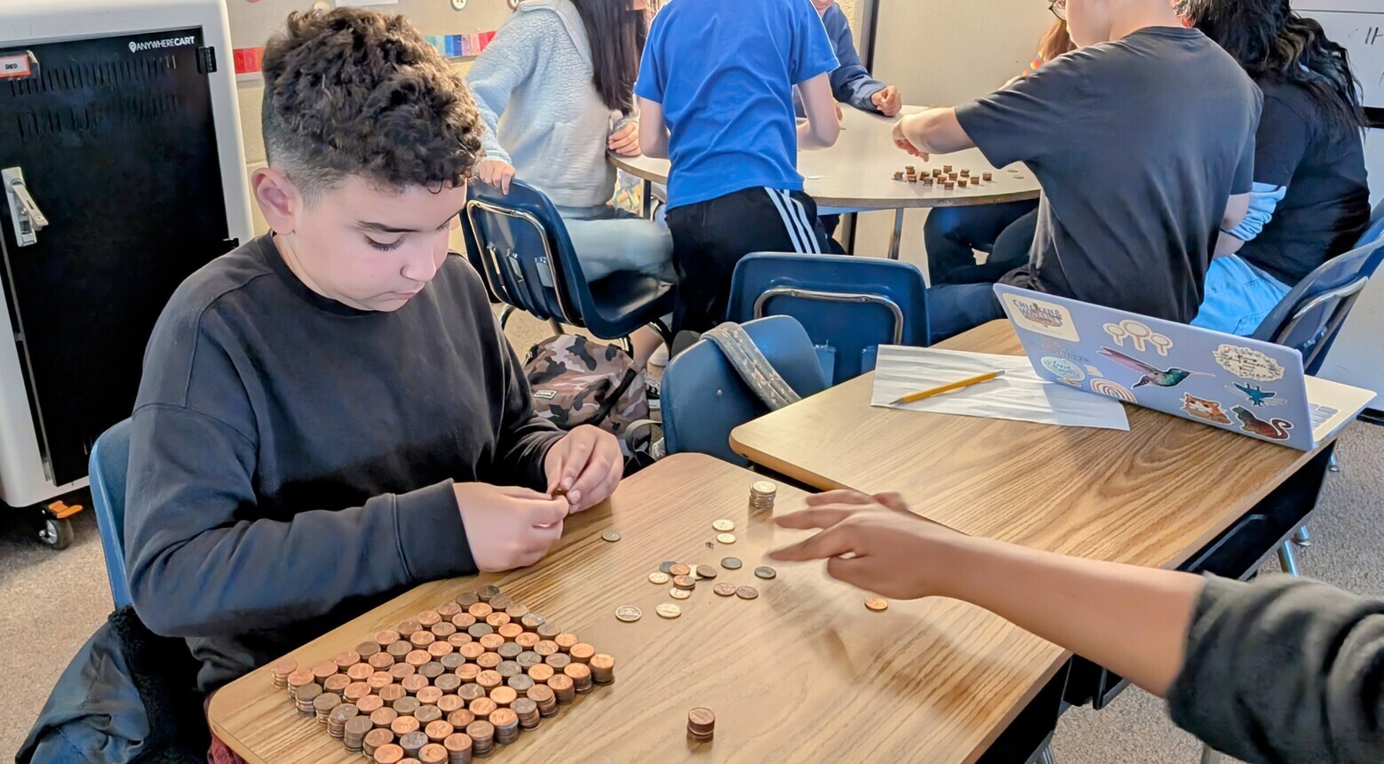 Students counting pennies.